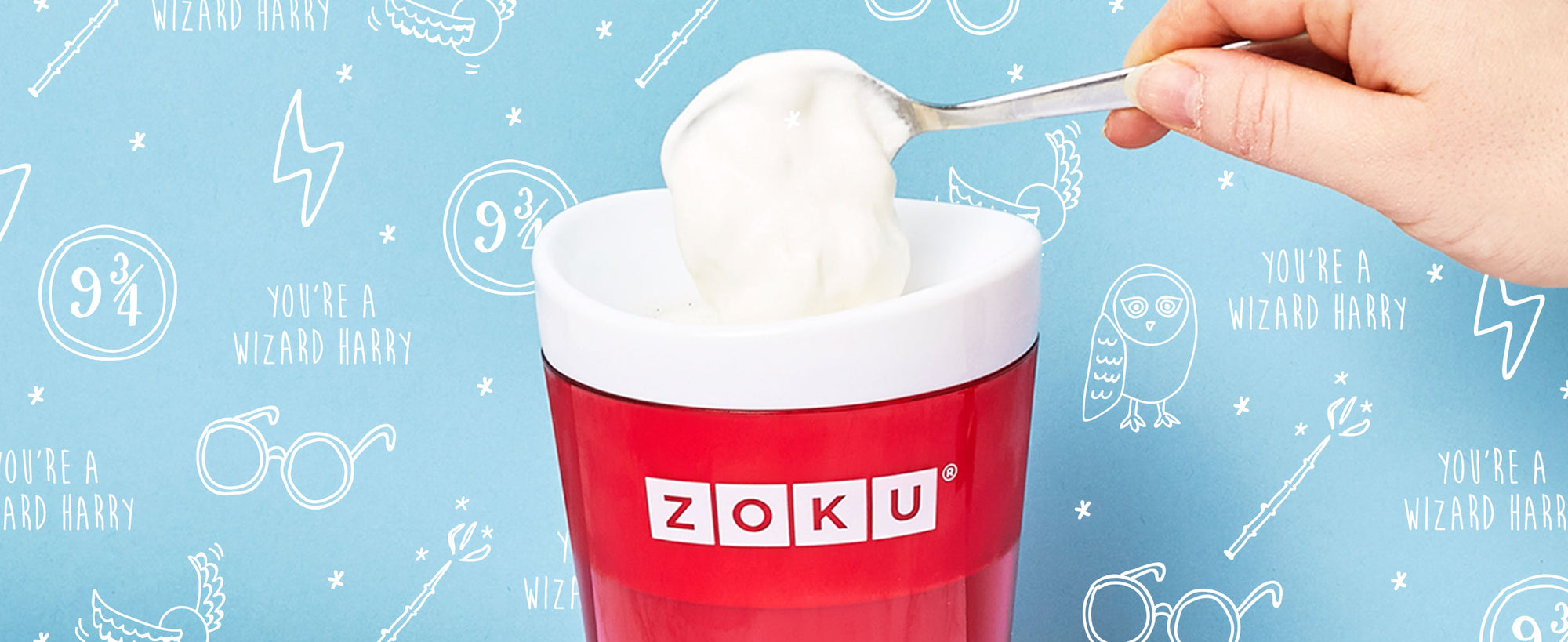 An image of ZOKU's Slush & Shake Maker with a hand spooning the topping onto a Homemade Frozen Butterbeer
