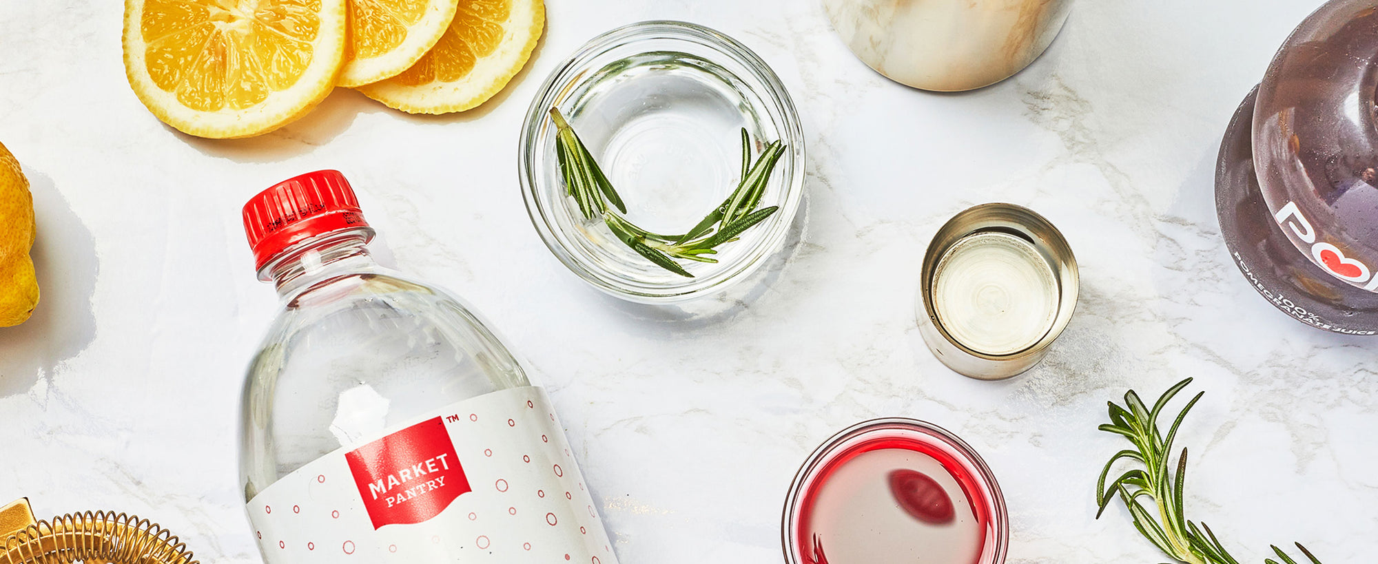 A flat lay image of the Rosemary Pomegranate Cocktail ingredients.
