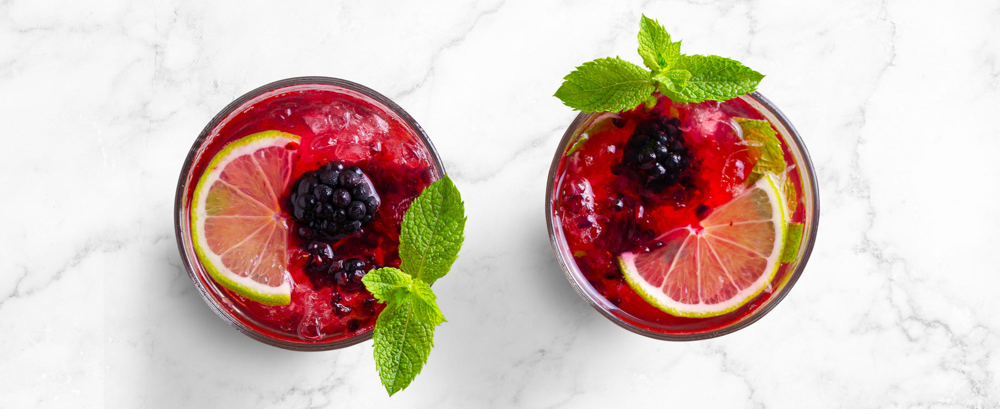 An overhead image of two Blackberry Mojitos.