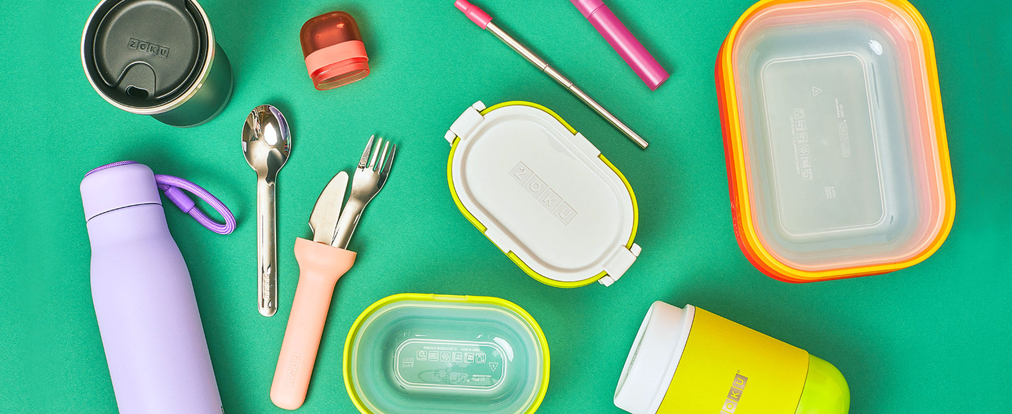 An overhead shot of reusable ZOKU products on a green surface.