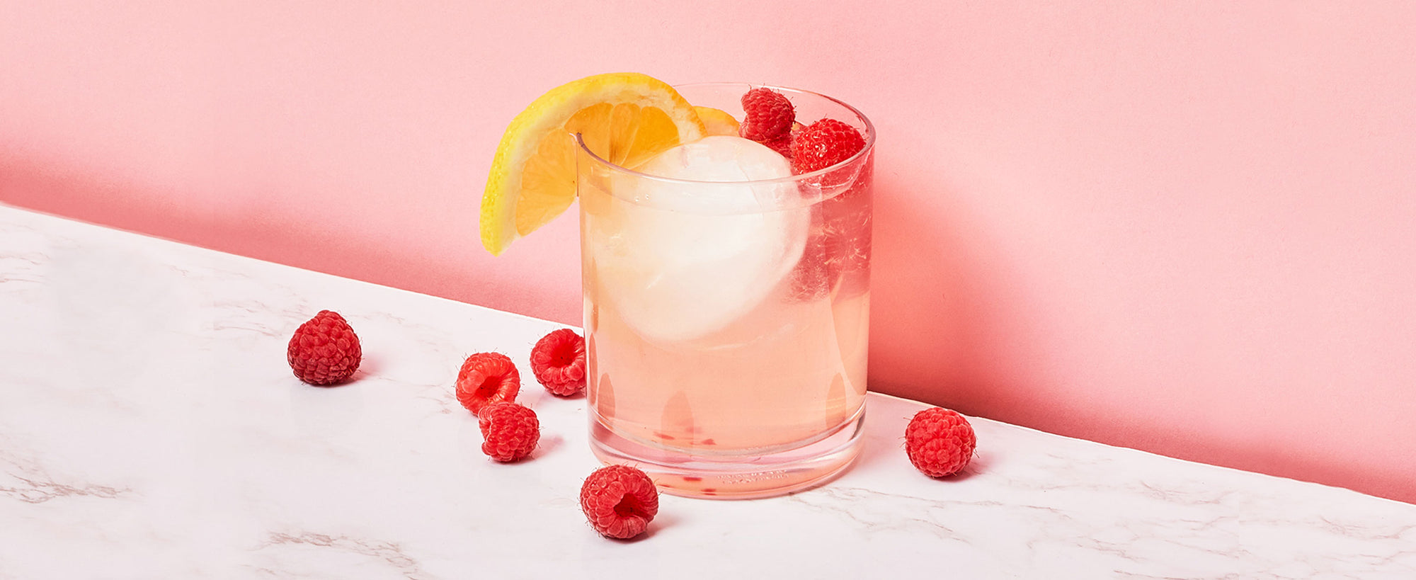 An image of ZOKU’s Raspberry Lemonade Cocktail against a pink background.