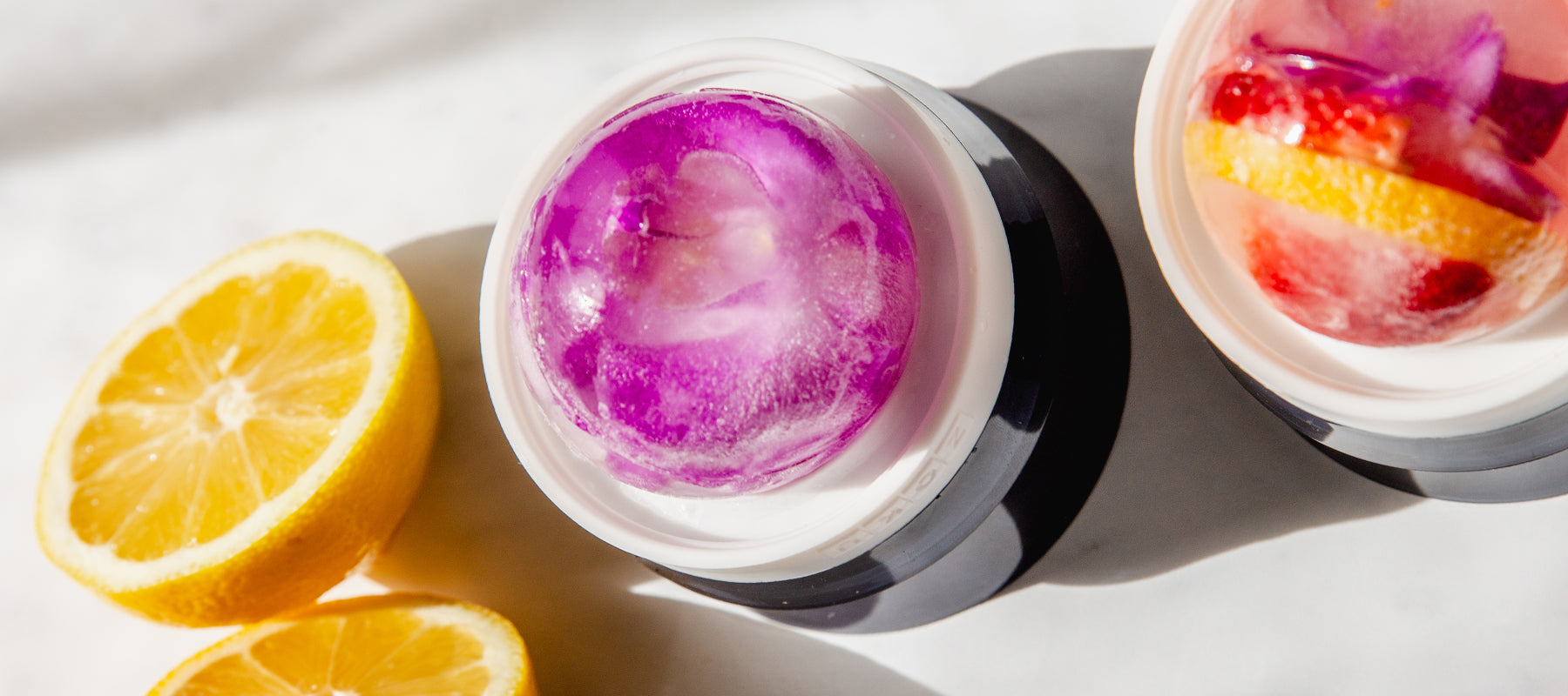 An image of floral infused spherical ice balls, created using the ZOKU Ice Ball Mold.